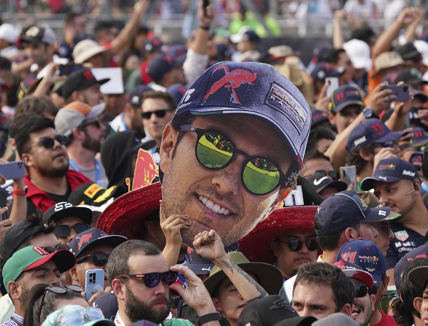  Fans celebrate with a cardboard cutout of Red Bull driver, Mexican Sergio Perez, at the end of the Formula One Mexico Grand Prix at the Hermanos Rodriguez racetrack in Mexico City, Sunday, Oct. 30, 2022. Perez placed third. (AP Photo/Fernando Llano)
