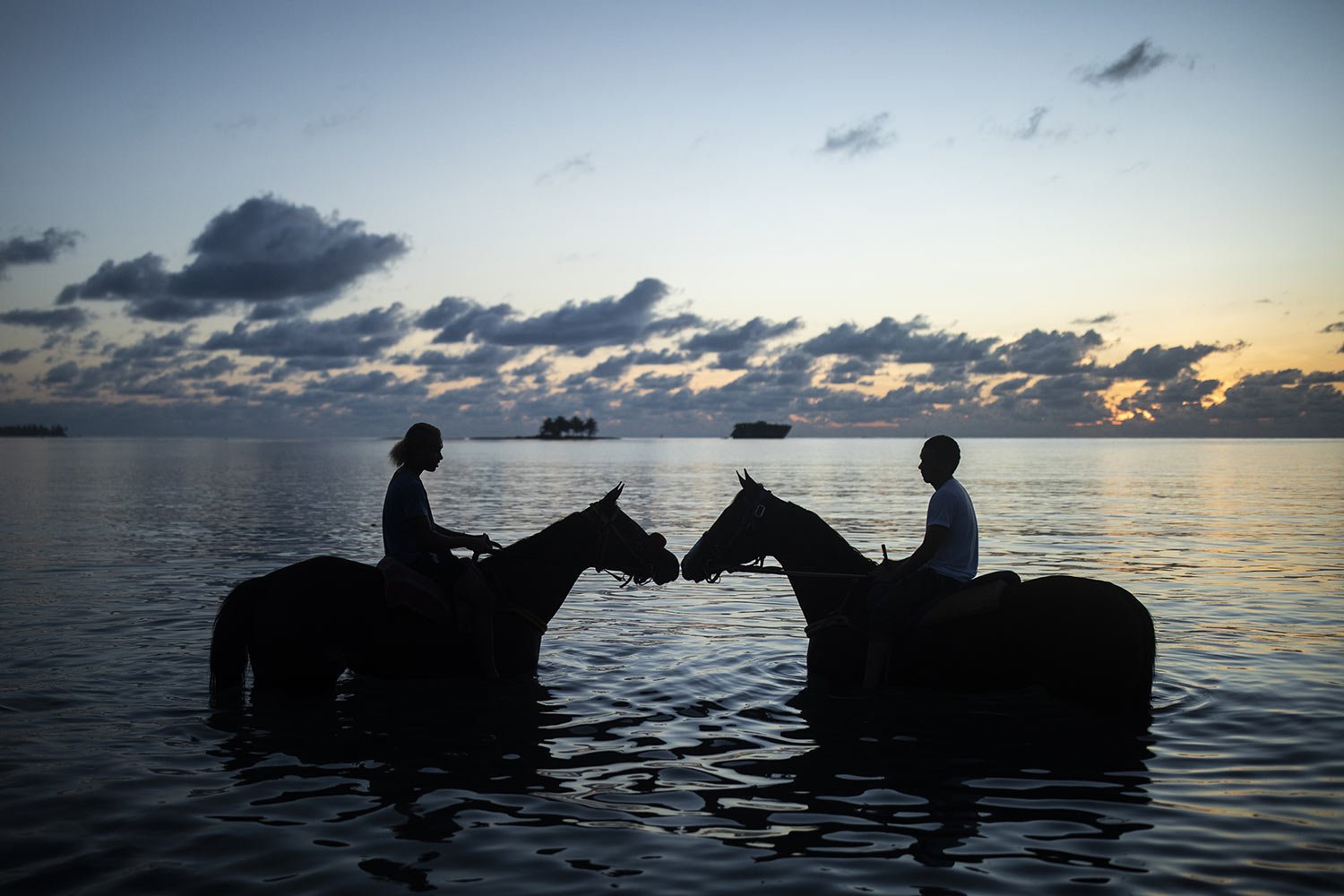  Riders bathe their racehorses in the sea in the early hours of the morning on San Andres Island in Colombia, Tuesday, Nov. 8, 2022. (AP Photo/Ivan Valencia) 