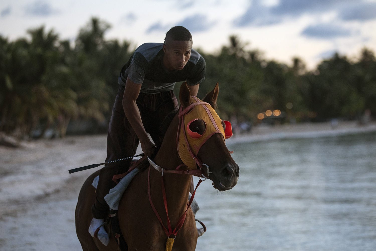  Horse trainer Jose Guerrero rides one of his thoroughbred horses on San Andres Island in Colombia, early Tuesday, Nov. 8, 2022. Guerrero, also a jockey, doesn't wear shoes when training on the beach. (AP Photo/Ivan Valencia) 