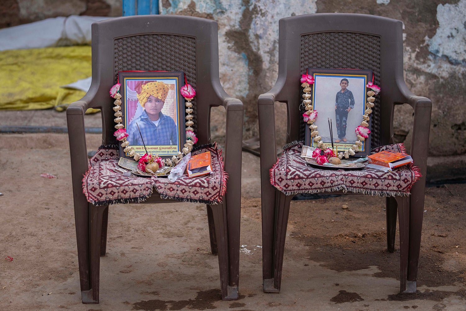  Garlands decorate the photograph of Yash Devadana, 12, left, and his cousin Raj Baghwanji Bhai, 13, victims of a bridge collapse, outside their house in Morbi town of western state Gujarat, India, Tuesday, Nov. 1, 2022.  (AP Photo/Rafiq Maqbool) 