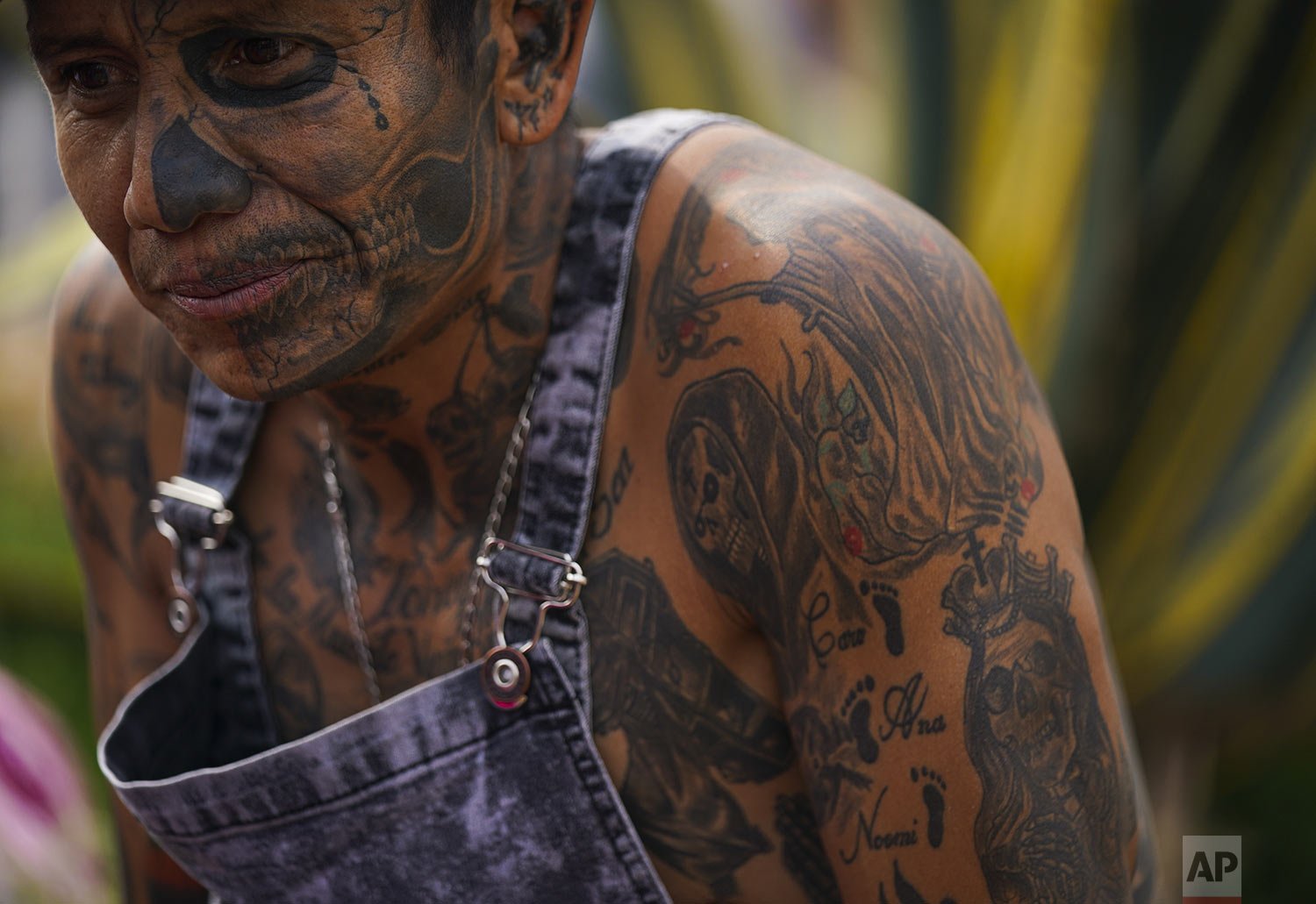  A devotee wears tattoos of "Nuestra Señora de la Santa Muerte," or Our Lady of Holy Death, as he waits in line to enter her altar in Mexico City's Tepito neighborhood, Tuesday, Nov. 1, 2022. (AP Photo/Fernando Llano) 