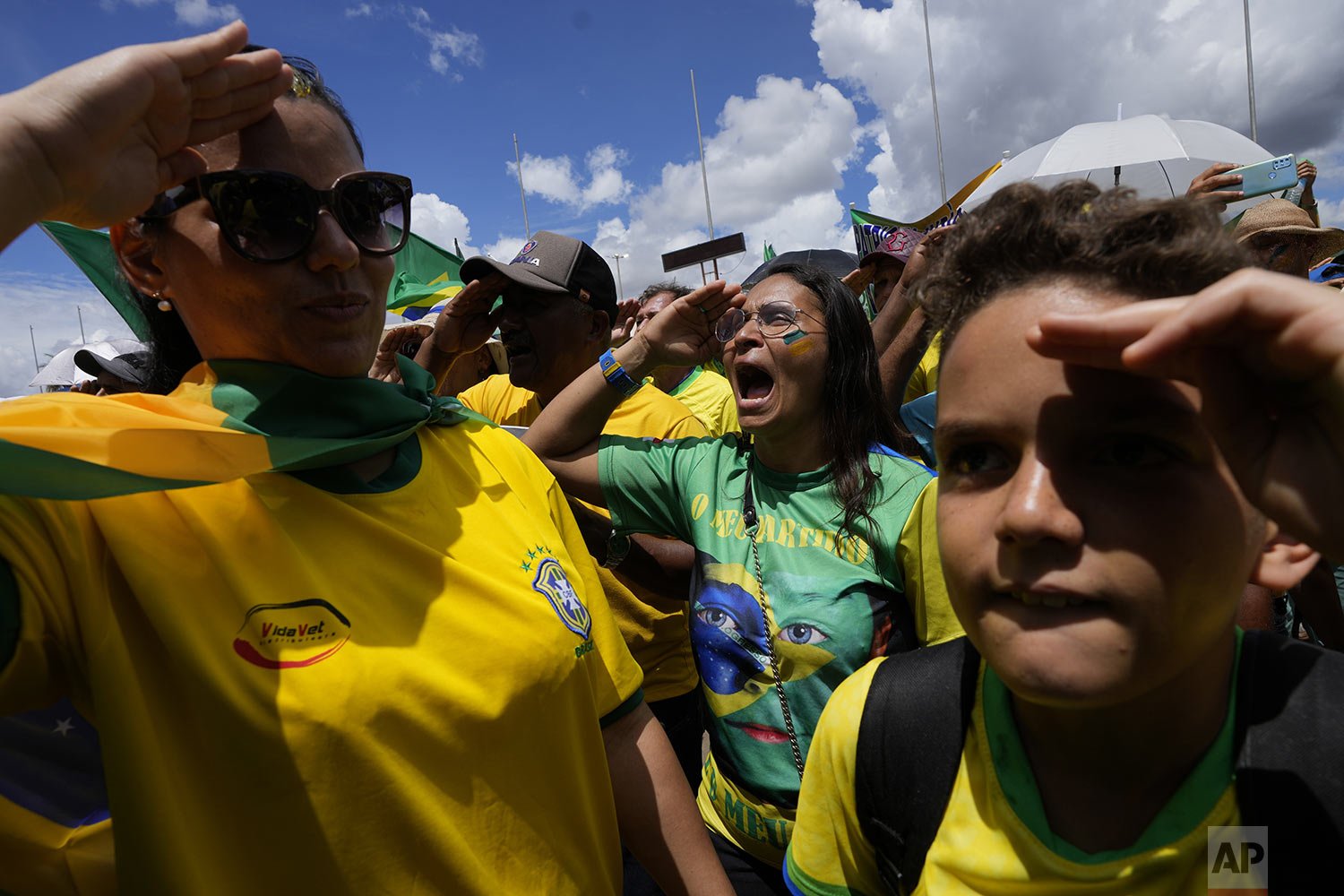  Supporters of Brazilian President Jair Bolsonaro salute and sing their national anthem during a protest against Bolsonaro's run-off election loss outside the Army headquarters in Brasilia, Brazil, Tuesday, Nov. 15, 2022. (AP Photo/Eraldo Peres) 