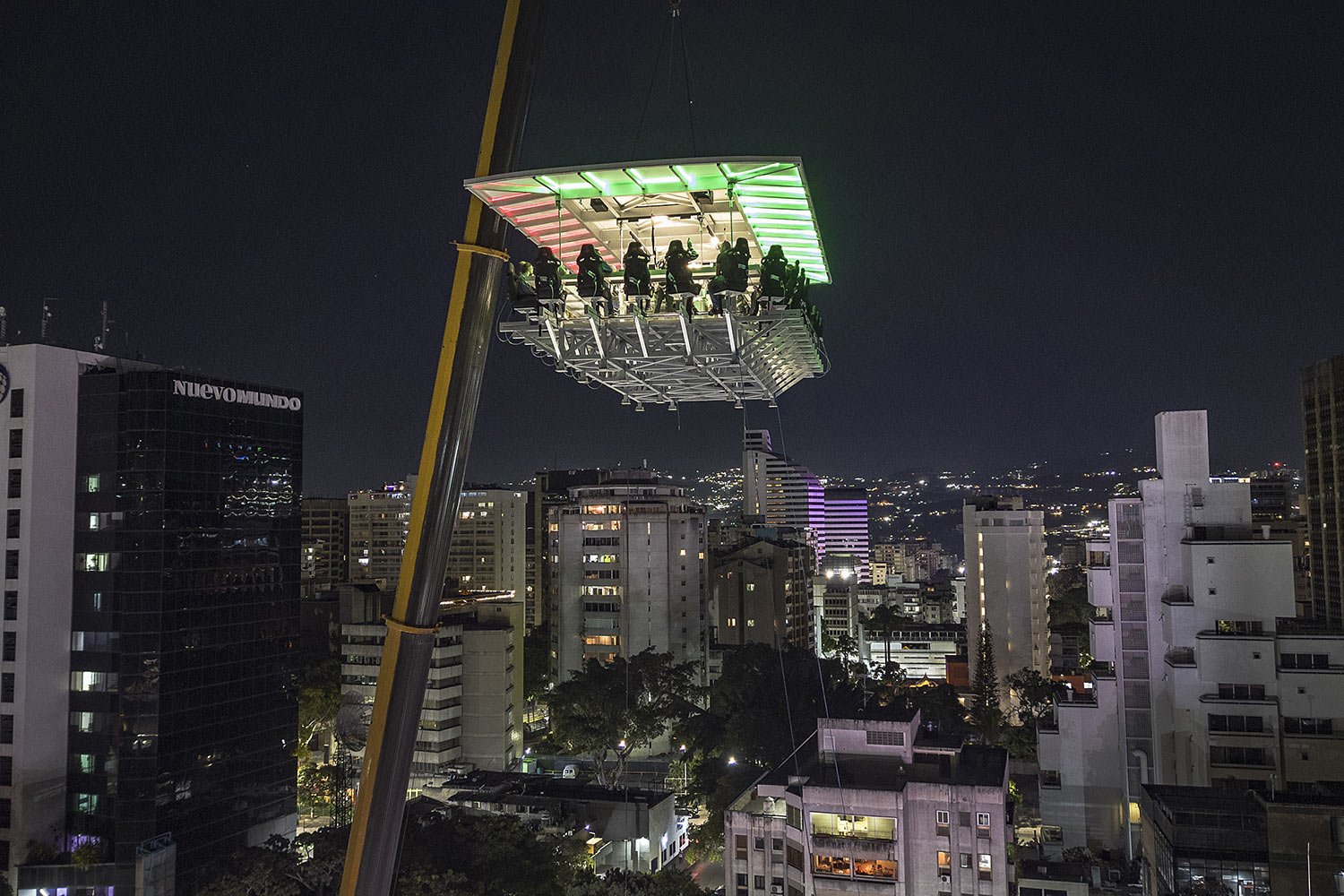  People dine in the air at the Altum restaurant in Caracas, Venezuela, late Thursday, Dec. 22, 2022. (AP Photo/Matias Delacroix) 