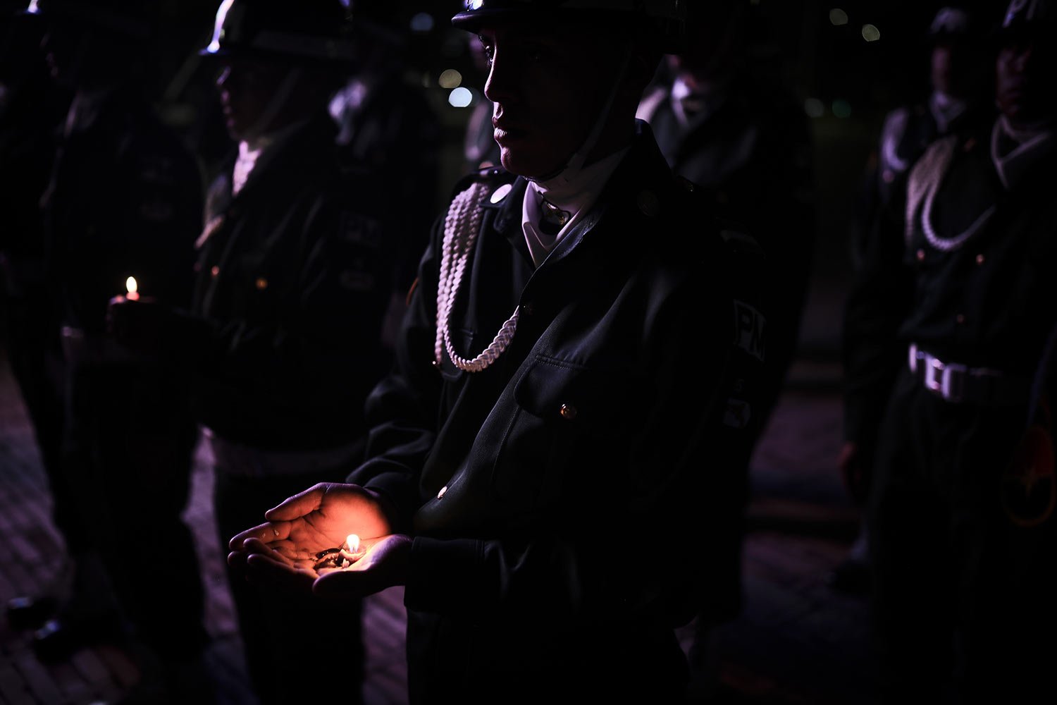  A soldier holds a candle during a vigil for fellow soldiers who were killed in a FARC dissident attack earlier in the week, at the Fallen Soldiers Monument, in Bogota, Colombia, Friday, Dec. 9, 2022.  (AP Photo/Ivan Valencia) 