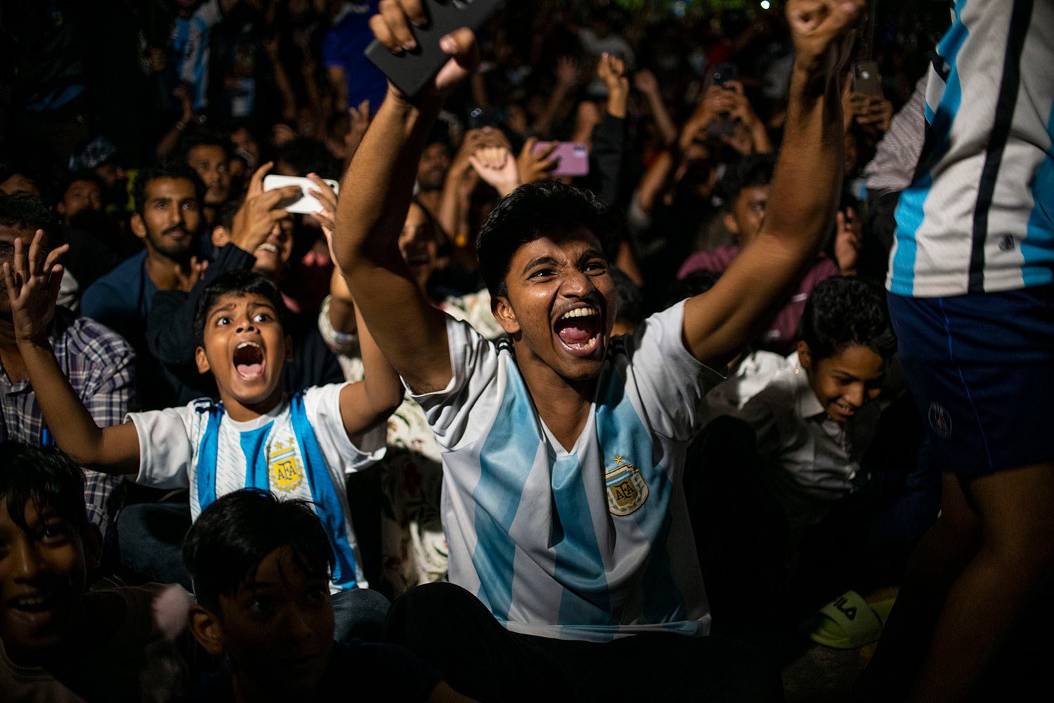  Argentina fans in Kochi, Kerala state, India, celebrate as they watch on a big screen, their team's first goal during the World Cup final soccer match between Argentina and France in Qatar, Sunday, Dec. 18, 2022. (AP Photo/R S Iyer) 