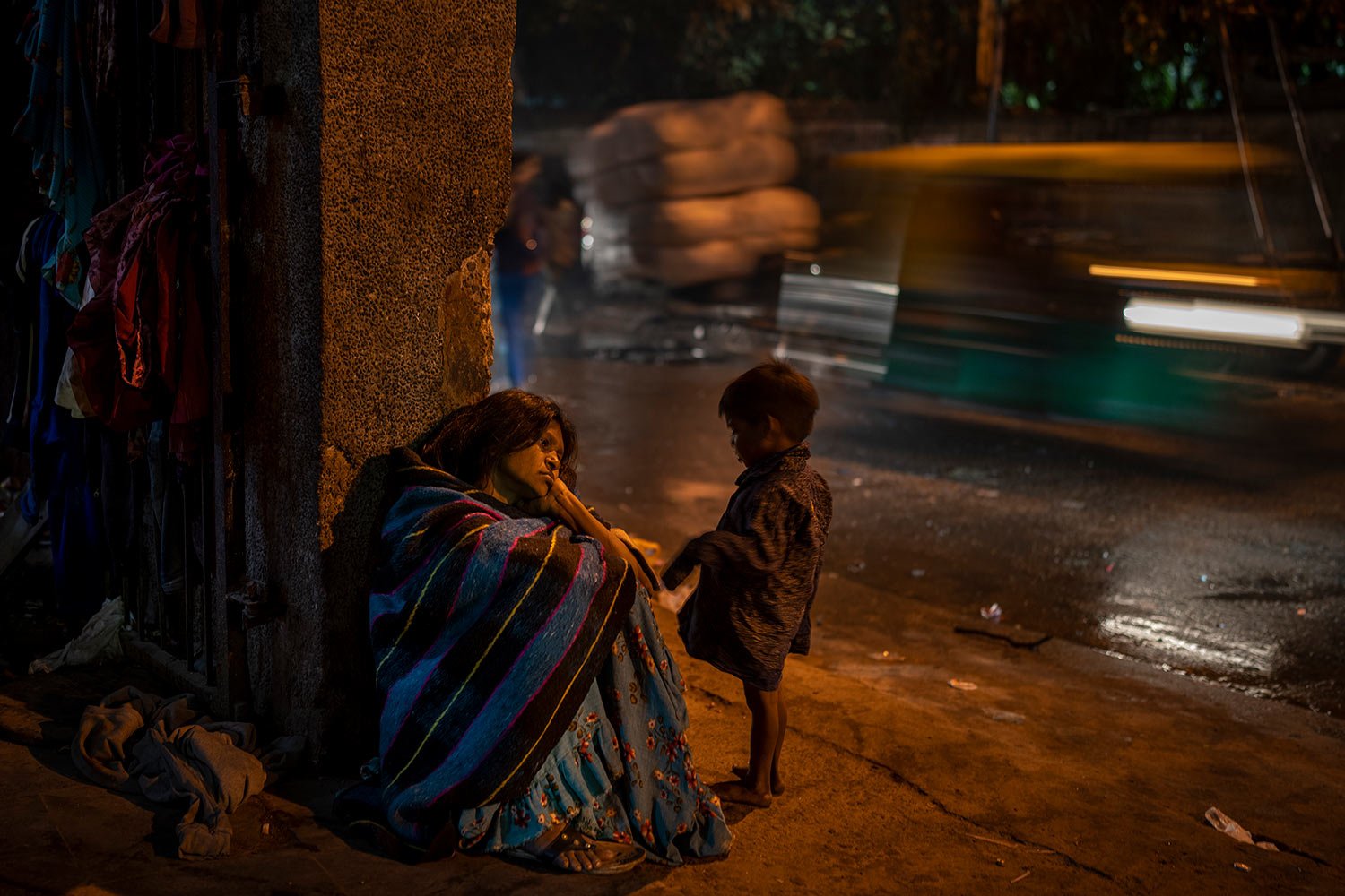  A homeless woman sits by the entrance to the a dilapidated shelter for homeless people in New Delhi, Dec. 30, 2022. (AP Photo/Altaf Qadri) 