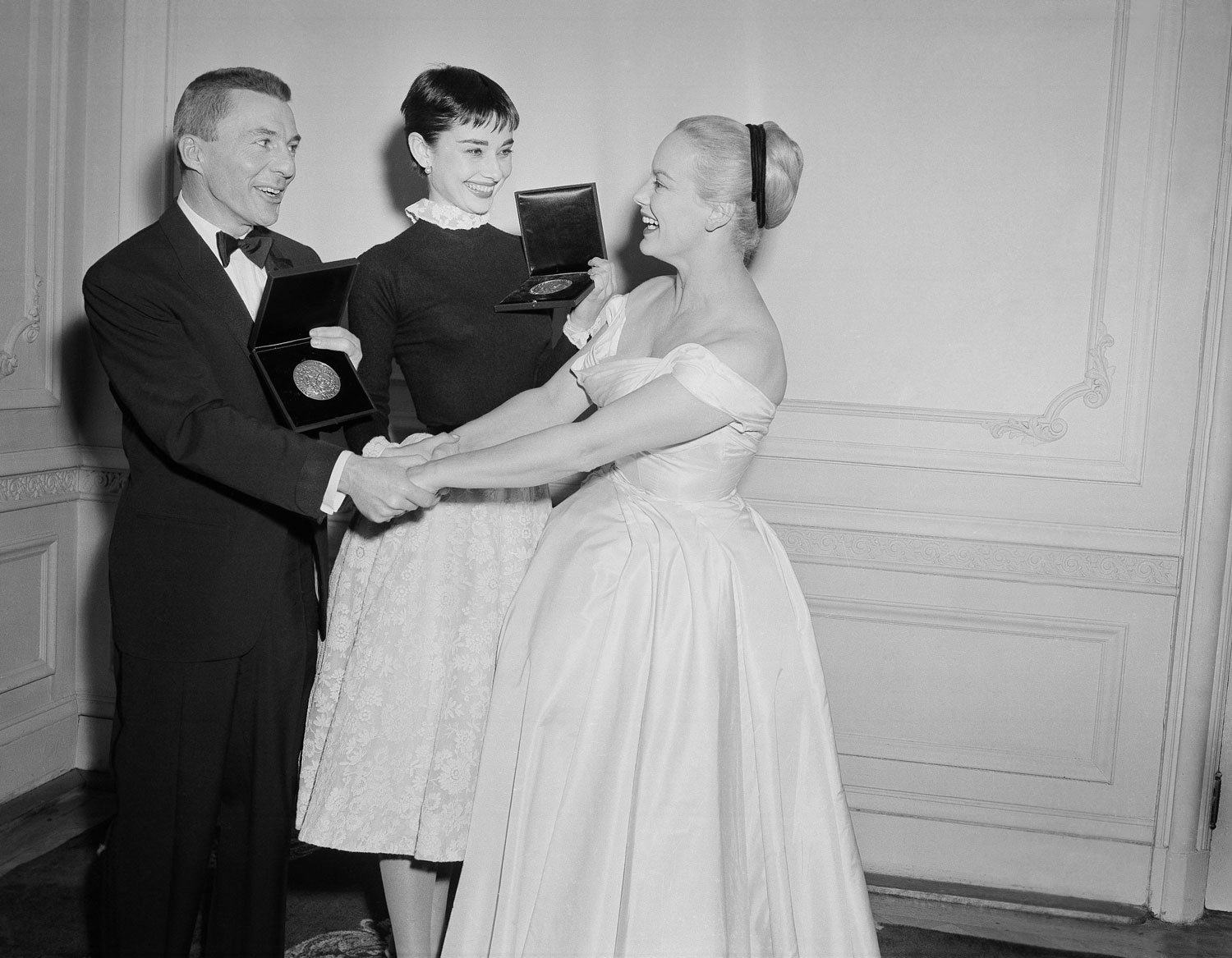  Actor David Wayne and Academy Award winning actress Audrey Hepburn, center, are congratulated by television star Faye Emerson after receiving the American Theater Wing’s Eighth Annual Tony Awards at the Hotel Plaza in New York City on March 28, 1954