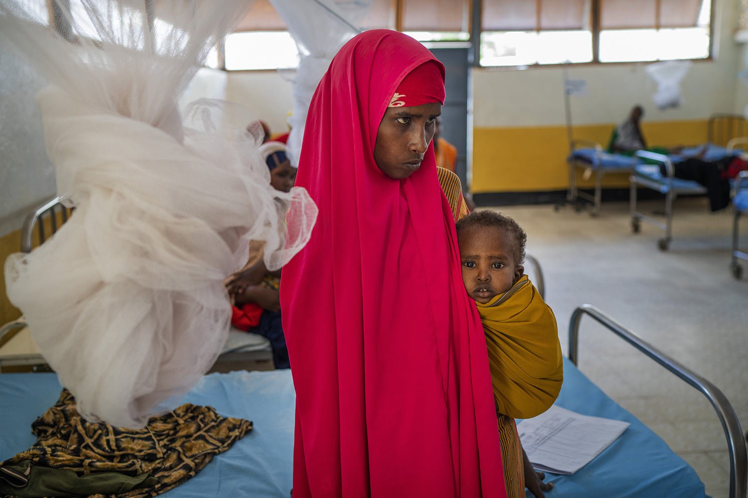  A woman holds a child at a clinic in Dollow, Somalia, Sept. 21, 2022. (AP Photo/Jerome Delay) 