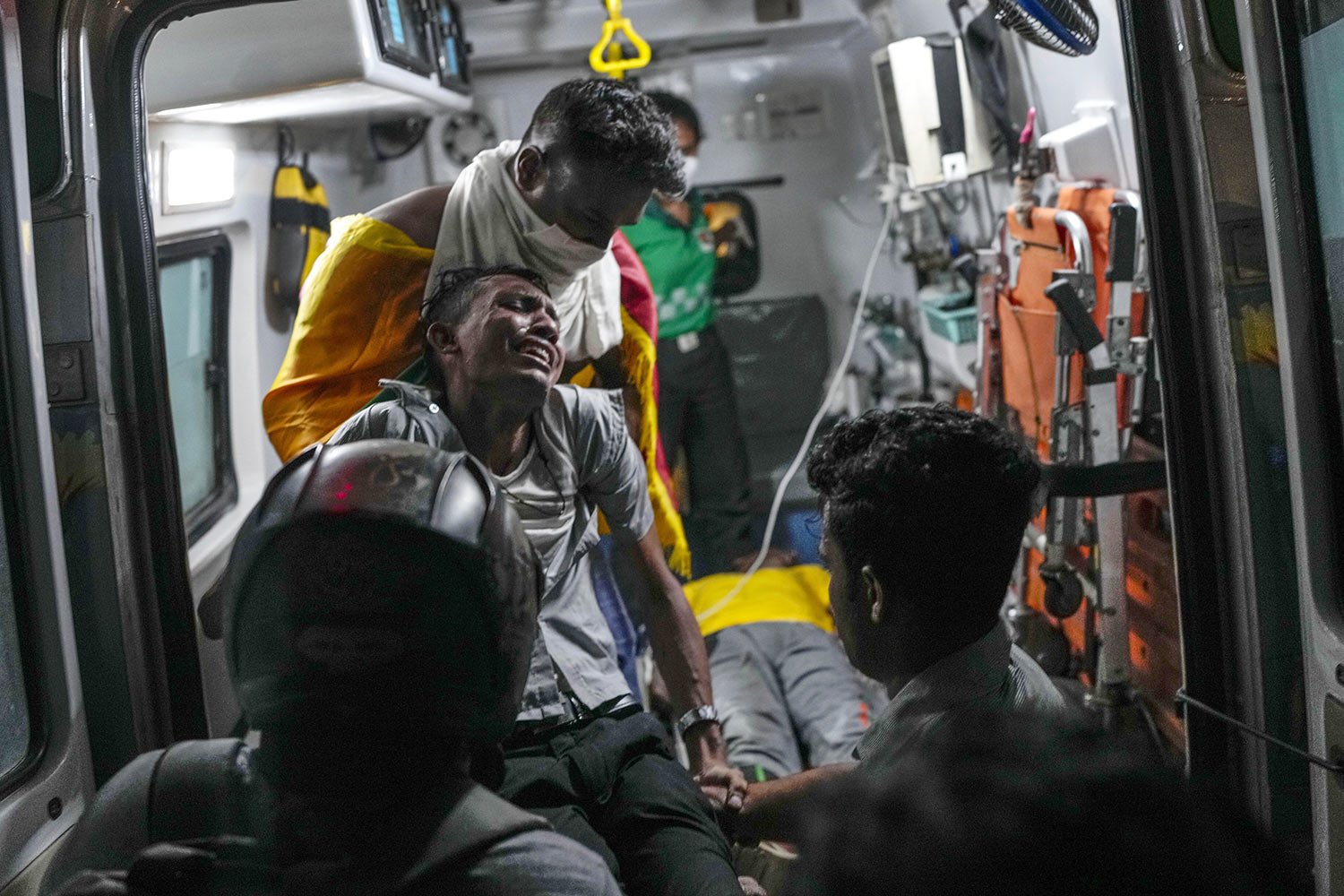  An injured protester is put into an ambulance during clashes with police near Parliament in Colombo, Sri Lanka, July 13, 2022. (AP Photo/Rafiq Maqbool) 