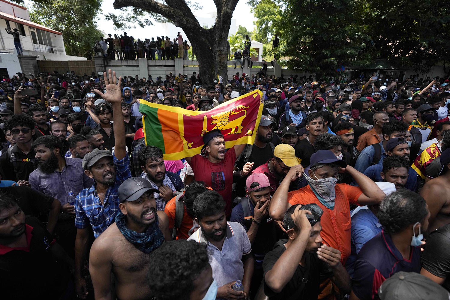  Protesters storm the office compound of Prime Minister Ranil Wickremesinghe, demanding he resign after President Gotabaya Rajapaksa fled the country amid an economic crisis, in Colombo, Sri Lanka, July 13, 2022. (AP Photo/Eranga Jayawardena) 