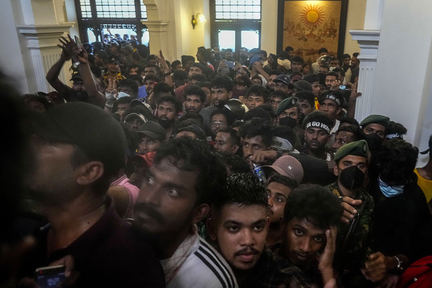  Protesters storm the office building of Prime Minister Ranil Wickremesinghe, demanding he resign after President Gotabaya Rajapaksa fled the country amid an economic crisis, in Colombo, Sri Lanka, July 13, 2022. (AP Photo/Rafiq Maqbool) 