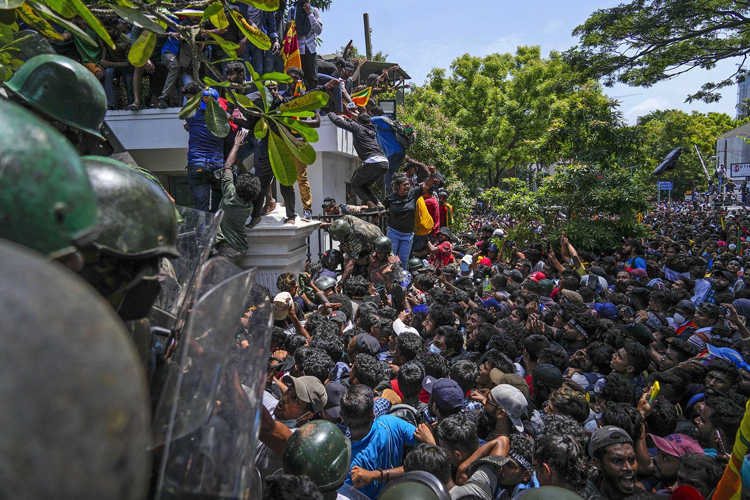  Protesters storm the Sri Lankan Prime Minister Ranil Wickremesinghe's office, demanding he resign after President Gotabaya Rajapaksa fled the country amid an economic crisis, in Colombo, Sri Lanka, July 13, 2022. (AP Photo/Rafiq Maqbool) 