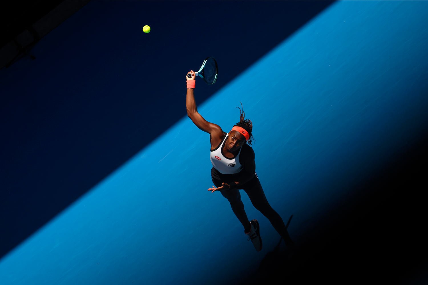  Coco Gauff of the U.S. serves to Jelena Ostapenko of Latvia during their fourth round match at the Australian Open tennis championship in Melbourne, Australia, Sunday, Jan. 22, 2023. (AP Photo/Asanka Brendon Ratnayake) 