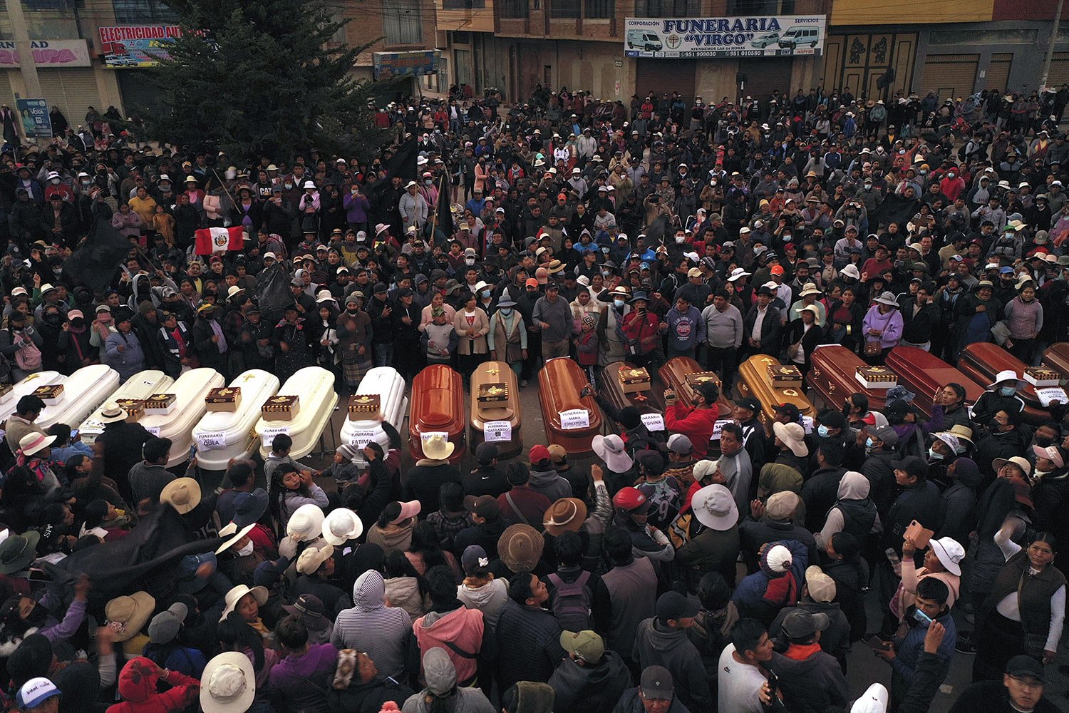  Residents surround coffins during a wake for the people who died during political unrest in Juliaca, Peru, Jan. 10, 2023. At least 17 people died in one day as protests seeking immediate elections resumed in rural areas of the country still loyal to