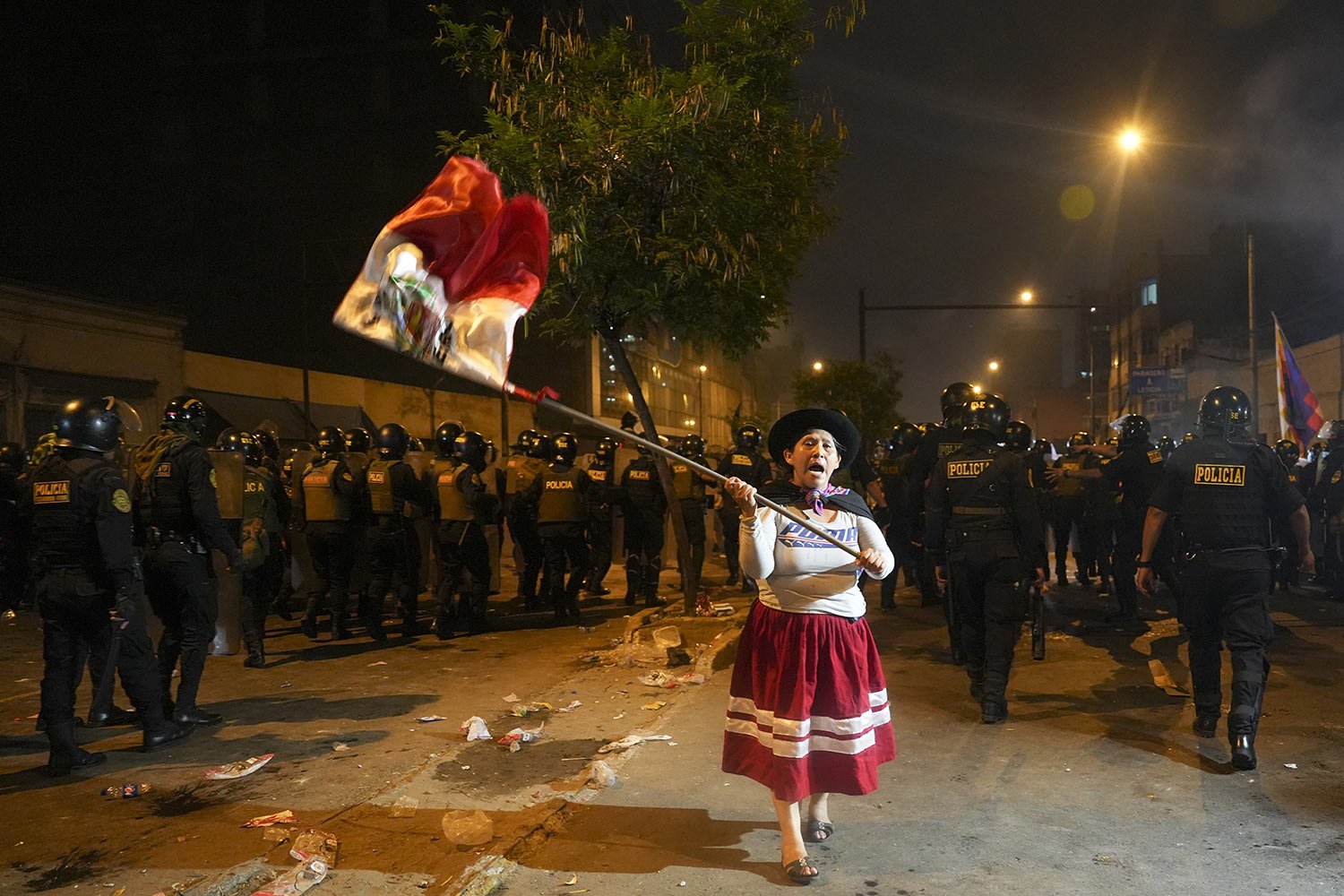  A woman waves a Peruvian flag during an anti-government protest in Lima, Peru, Jan. 20, 2023. Protesters are seeking the resignation of President Dina Boluarte, the release from prison of ousted President Pedro Castillo and immediate elections. (AP 