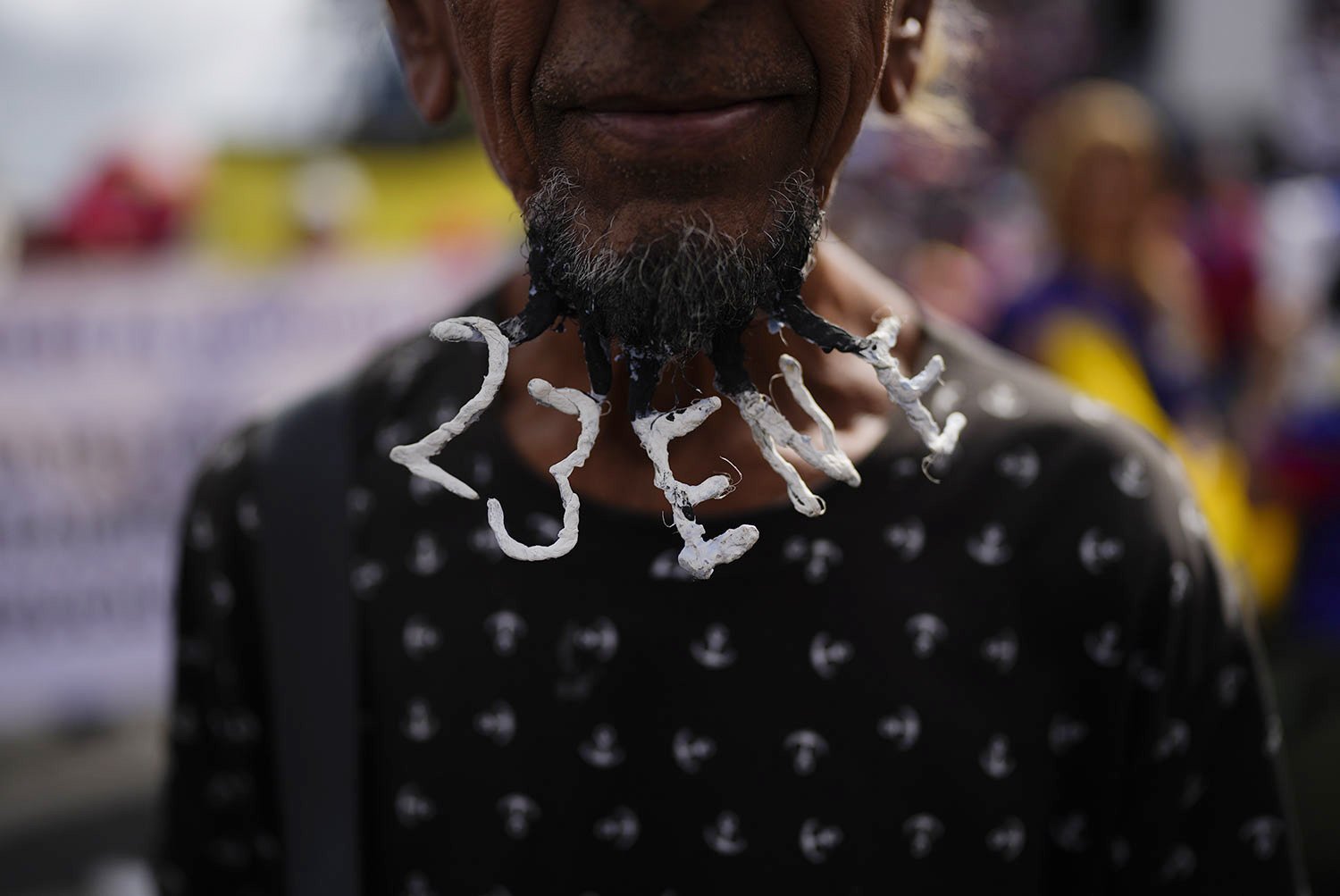  A demonstrator wears the date Jan. 23 woven into his beard at an event marking the anniversary of the 1958 coup that overthrew dictator Marcos Perez Jimenez in Caracas, Venezuela, Jan. 23, 2023. (AP Photo/Ariana Cubillos) 
