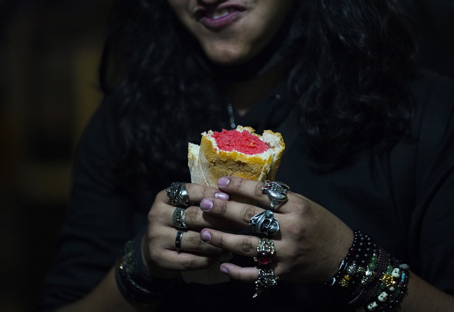  A youth who plays guitar in a rock band eats a pink tamal before his show at a street tamales shop in downtown Mexico City, Jan. 26, 2023. (AP Photo/Fernando Llano) 
