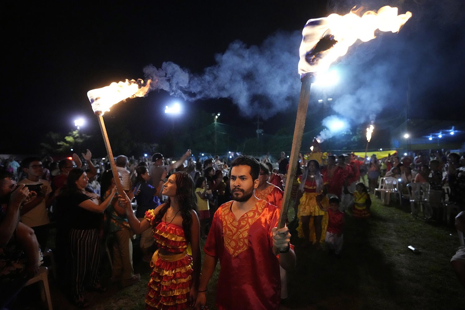  Members of the Paraguay-African cultural group Kamba Cua carry torches during an Epiphany celebration honoring Saint Balthazar, one of the Three Kings, in Fernando de la Mora, Paraguay, early Jan. 8, 2023. The procession is a tradition that keeps th