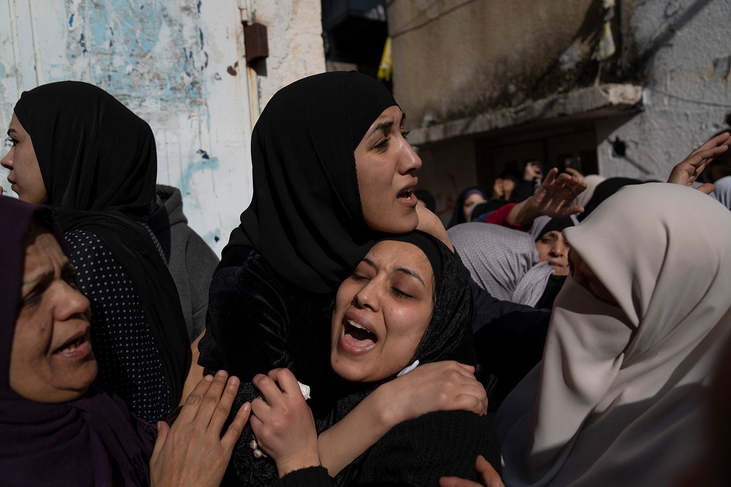  Amal and Amani Abu Junaid sisters of Ahmed Abu Junaid, 21 cry during his funeral in the West Bank refugee camp of Balata, Nablus, Thursday, Jan. 12, 2023.  (AP Photo/Nasser Nasser) 