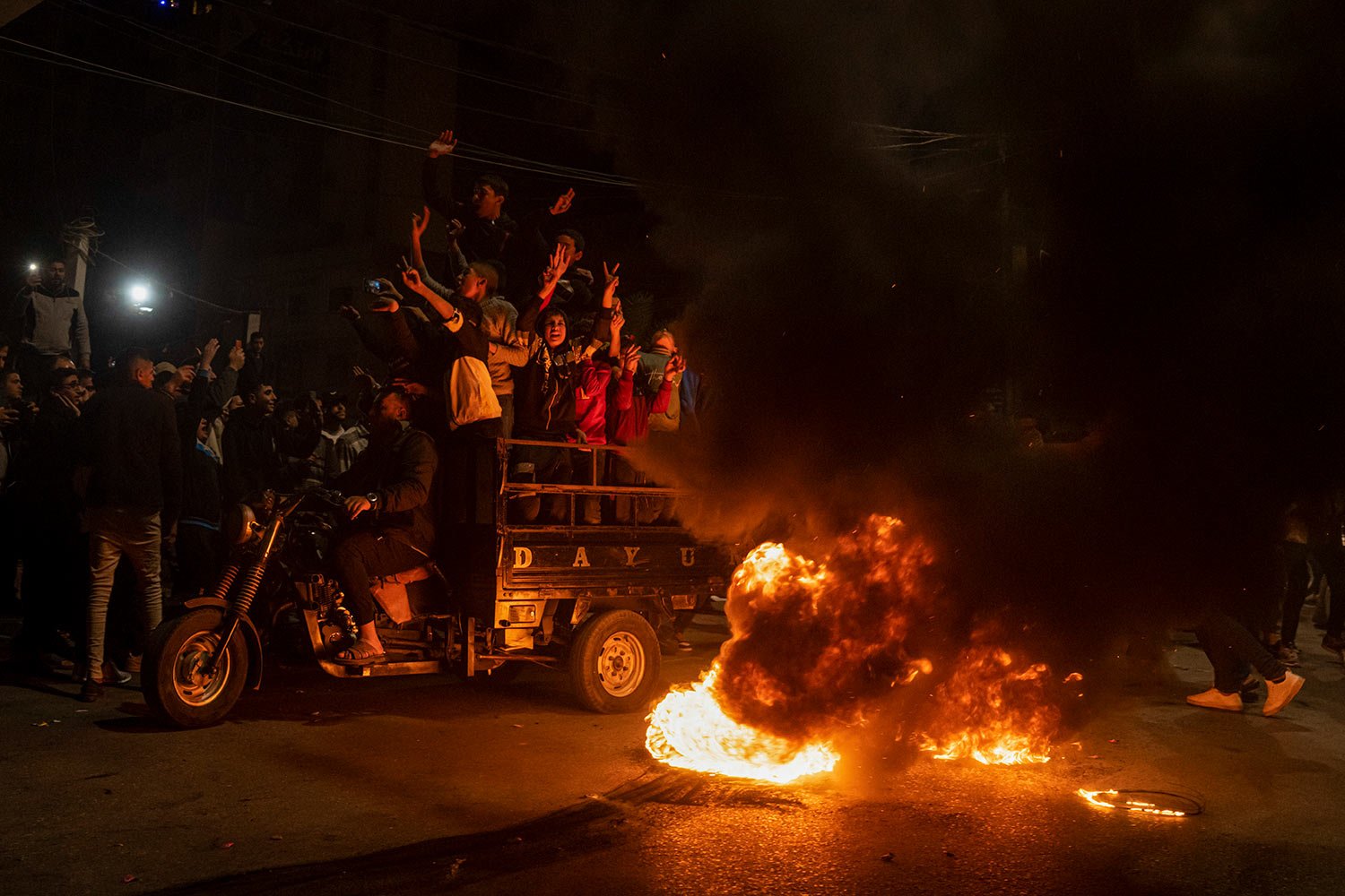  Palestinians celebrate after a shooting attack near a synagogue in Jerusalem, in Gaza City, Friday, Jan. 27, 2023. (AP Photo/Fatima Shbair) 