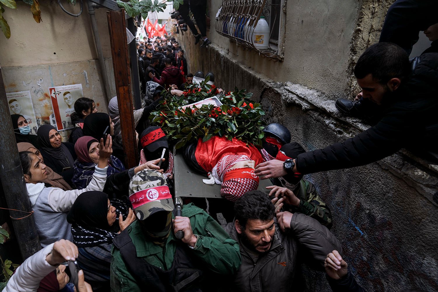  Mourners carry the body of 15-year-old Palestinian Adam Ayyad during his funeral in the West Bank city of Bethlehem, Tuesday, Jan. 3, 2023. (AP Photo/Mahmoud Illean) 
