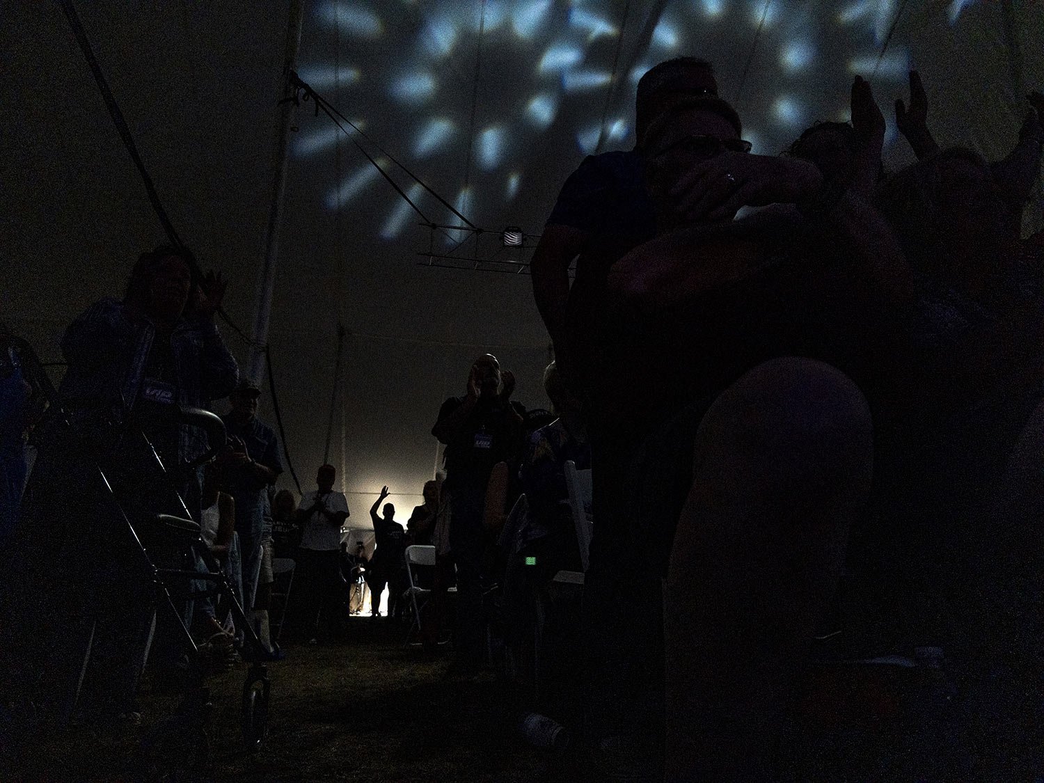  An audience member stands at the edge of the tent during the ReAwaken America Tour at Cornerstone Church in Batavia, N.Y., Aug. 12, 2022. (AP Photo/Carolyn Kaster) 
