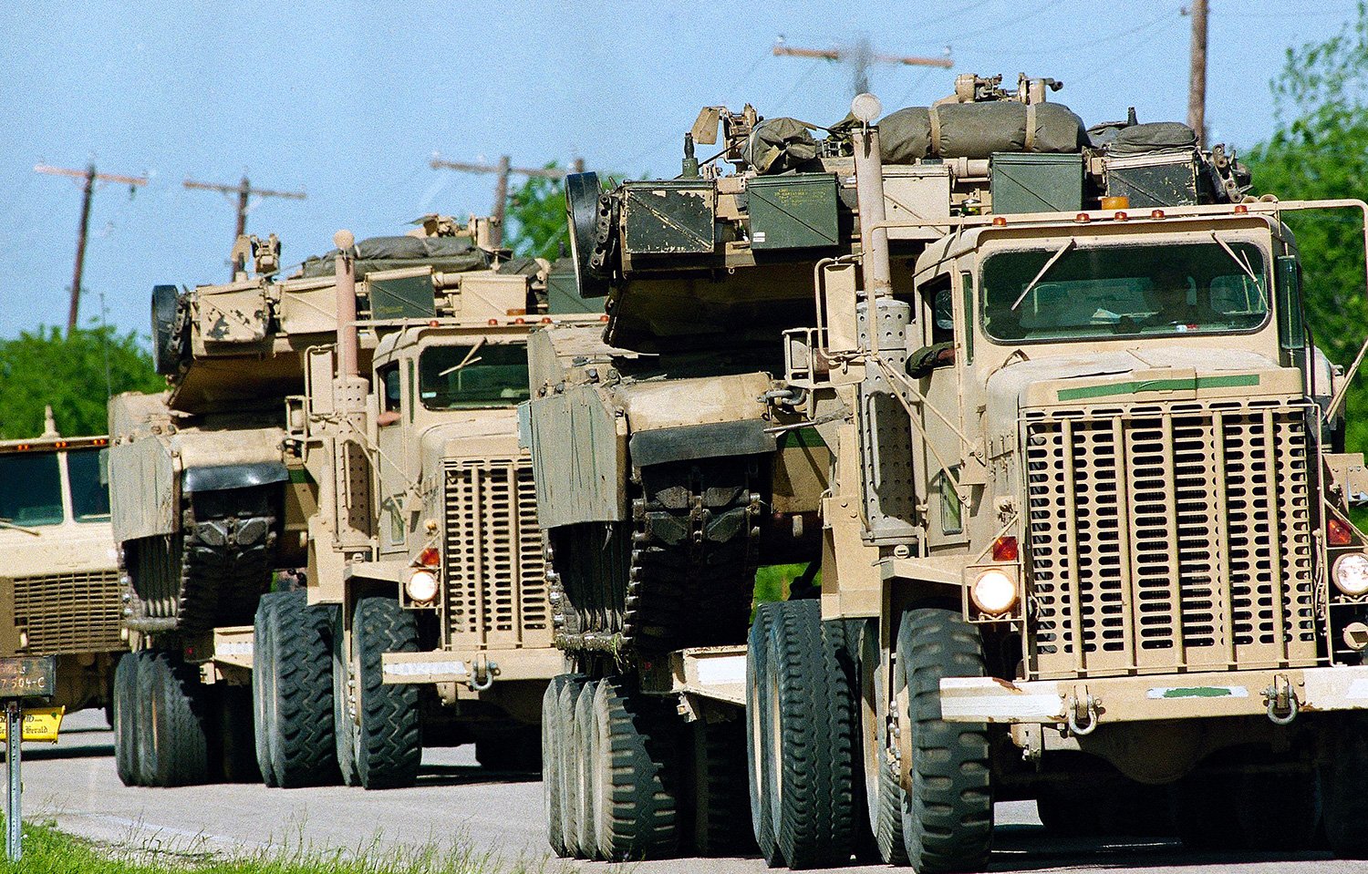  Armored vehicles loaded on trucks pass through a roadblock as they depart the scene of Monday’s fatal fire at the Branch Davidian compound in Waco, Texas on Tuesday, April 21, 1993. (AP Photo/Susan Weems) 