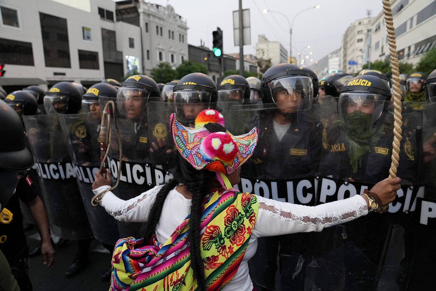  An anti-government protester challenges the police in Lima, Peru, Thursday, Feb. 9, 2023. Protesters seek immediate elections, the resignation of President Dina Boluarte, the release of President Pedro Castillo who was ousted and arrested for trying
