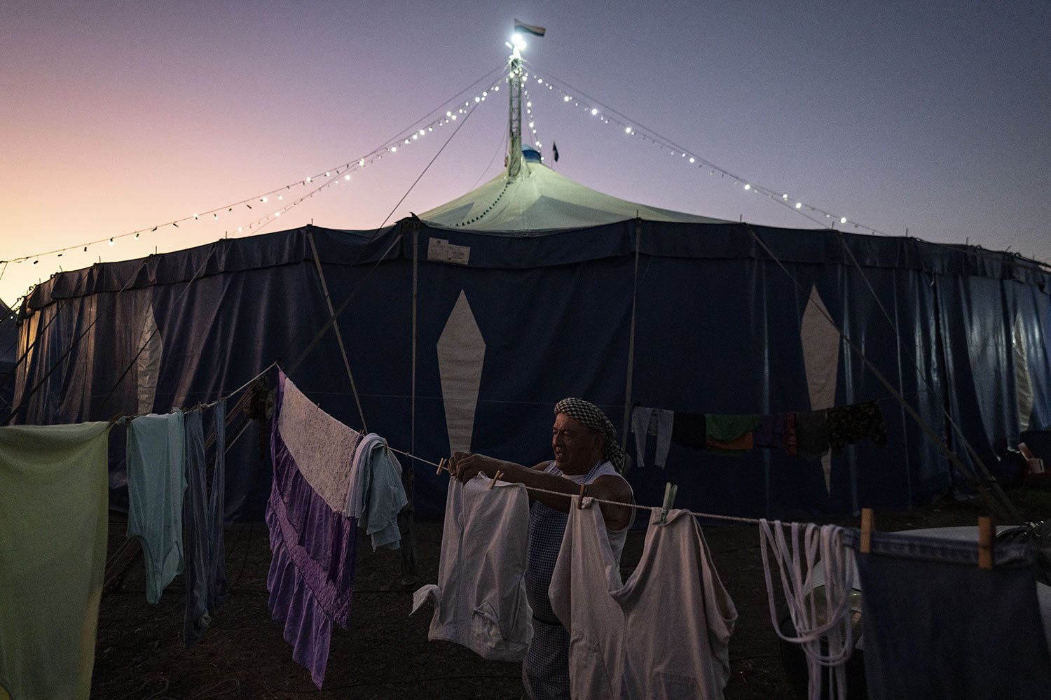  Timoteo Circus performer Arturo Peña hangs his wash on a clothesline on the outskirts of Santiago, Chile, Saturday, Dec. 10, 2022. Peña performs the part of  “The Crazy Purse Lady,” a role that has allowed him to escape life in the countryside and g