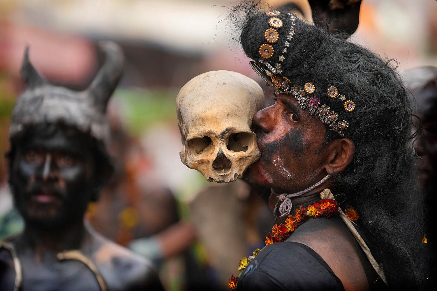  A Hindu devotee of Lord Shiva holds a human skull with his teeth as he takes part in a religious procession on the occasion of the Maha Shivratri festival in Prayagraj, in the northern Indian state of Uttar Pradesh, Saturday, Feb. 18, 2023. (AP Phot