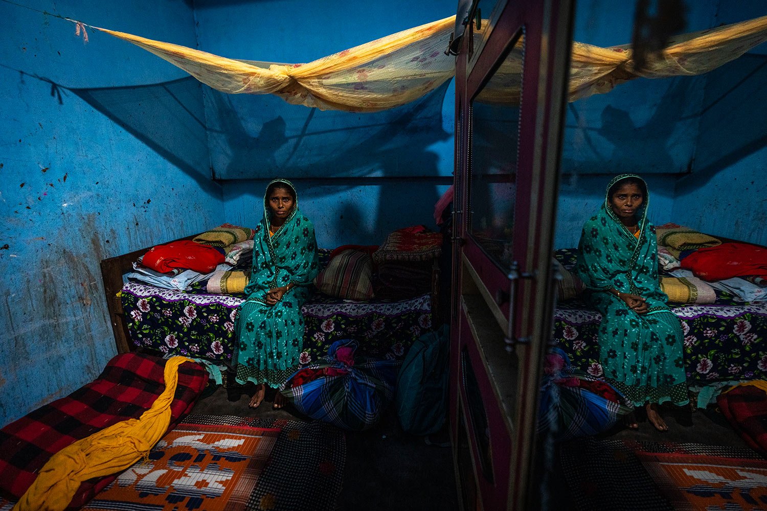  Ashiya sits on her bed after her son Siddique Ali, 23, was picked up by the police in Guwahati, India, Saturday, Feb. 4, 2023. (AP Photo/Anupam Nath) 