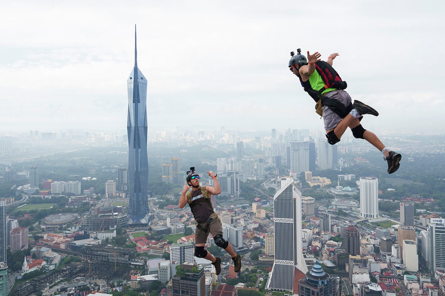  A pair of BASE jumpers dive from the Kuala Lumpur Tower during the KL Tower International Jump in Kuala Lumpur, Malaysia, Friday, Feb. 3, 2023. (AP Photo/Vincent Thian) 