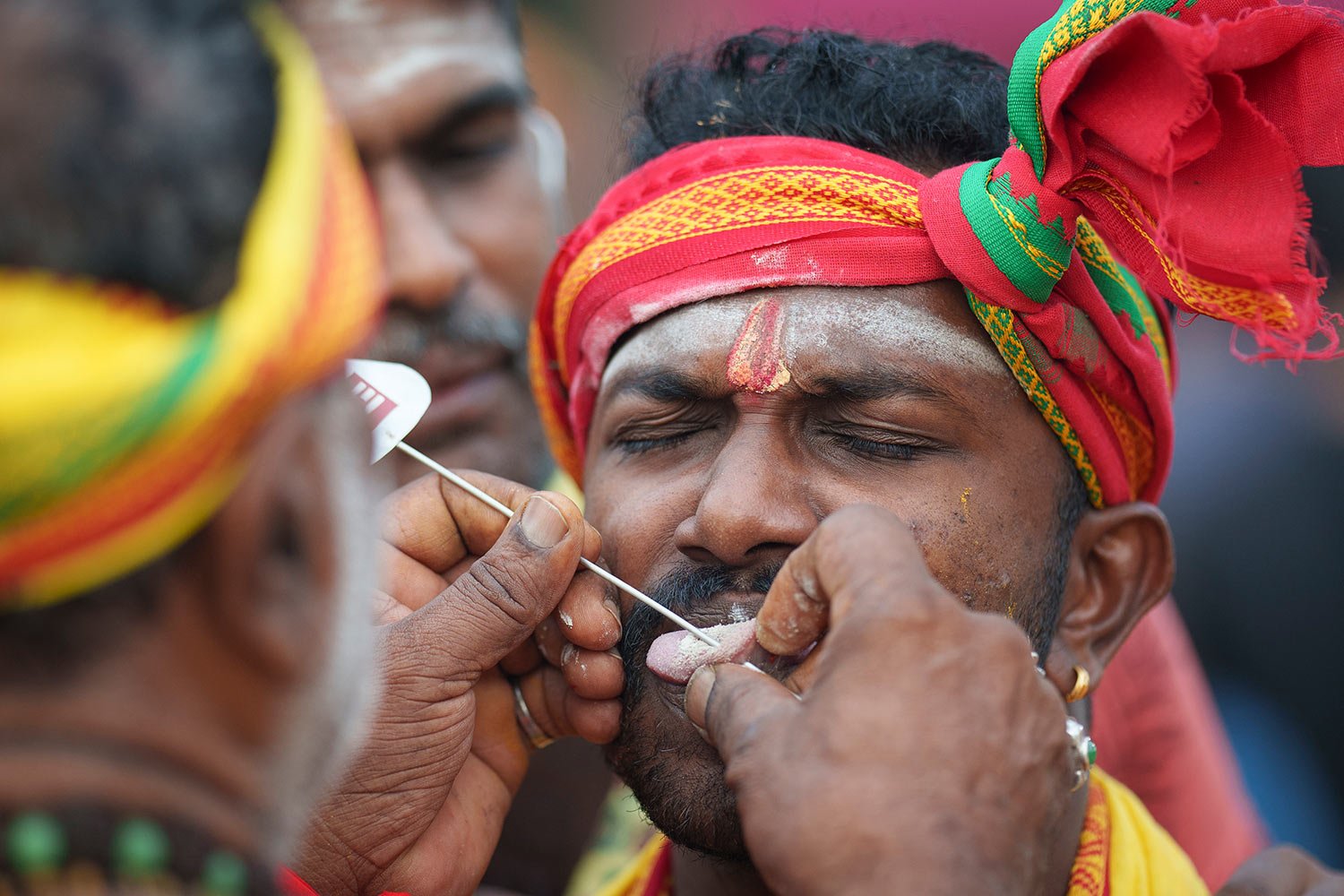  A Hindu devotee gets his tongue pierced with a metal rod during the Thaipusam festival celebrations at Batu Caves, in Kuala Lumpur, Malaysia, Sunday, Feb. 5, 2023.  (AP Photo/Vincent Thian) 