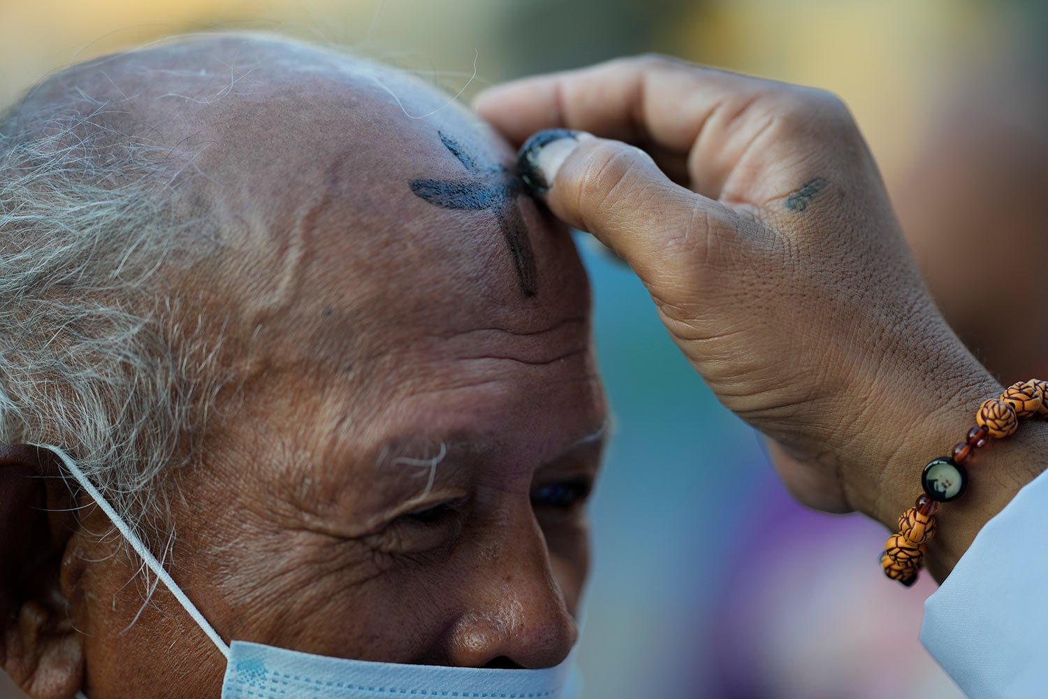  A lay minister places ash on the forehead of a devotee during Ash Wednesday rites Feb. 22, 2023, outside a church in downtown Manila, Philippines. (AP Photo/Aaron Favila) 