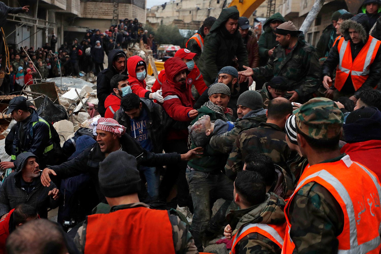  Civil defense workers and security forces carry an earthquake victim as they search through the wreckage of collapsed buildings in Hama, Syria, Monday, Feb. 6, 2023. (AP Photo/Omar Sanadiki) 
