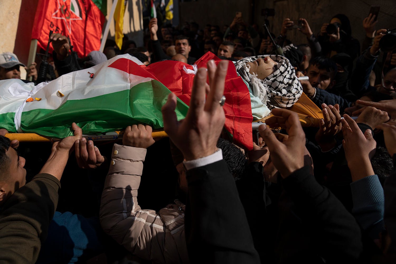  Mourners carry the body of Mahmoud Al-Aydi, 17 during his funeral in the West Bank refugee camp of Faraa, near Jenin, Tuesday, Feb. 14, 2023. (AP Photo/Nasser Nasser) 