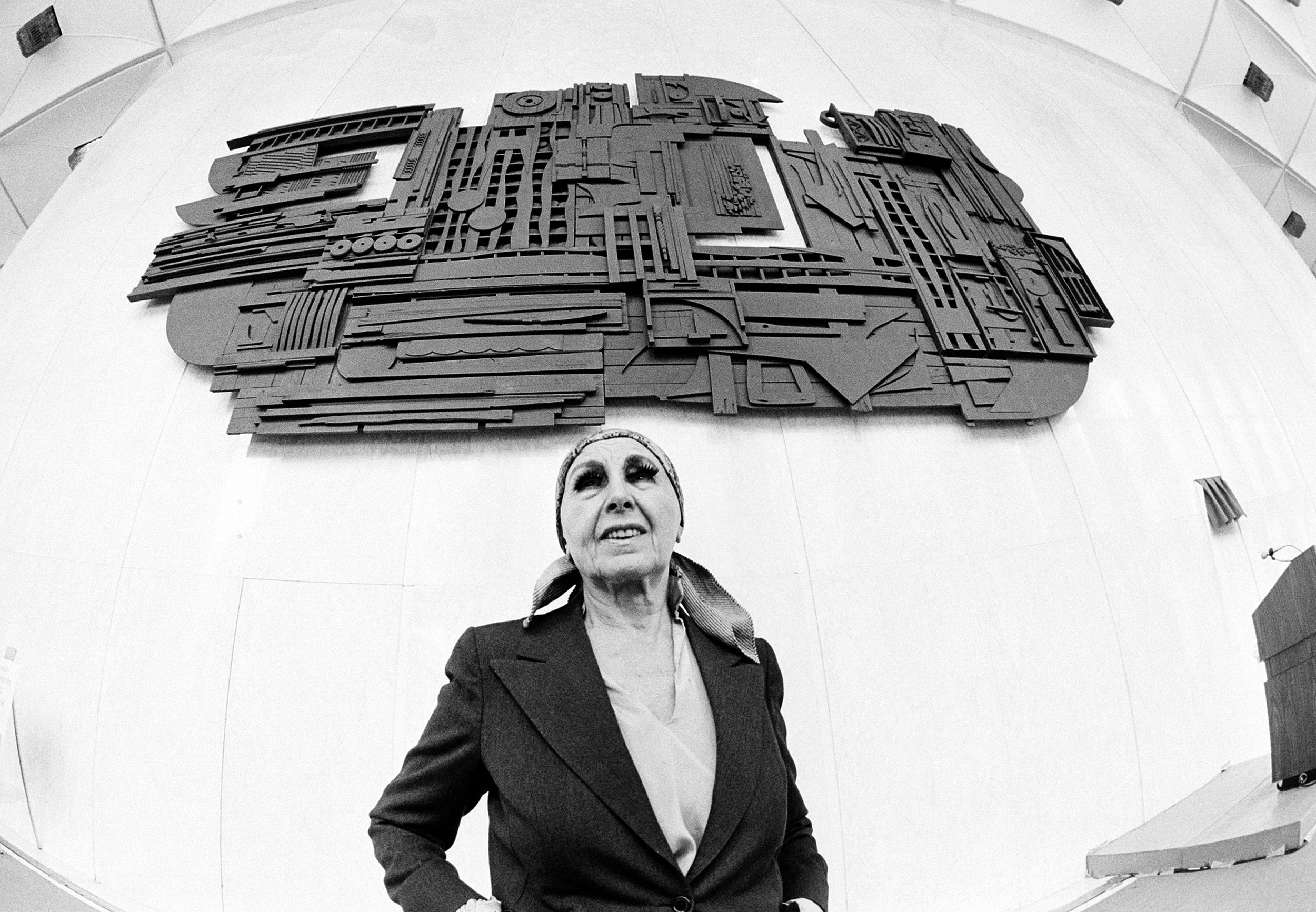  Artist Louise Nevelson poses beneath her work "Sky Gate, New York" during its unveiling at New York's World Trade Center in lower Manhattan on Tues. Dec. 12, 1978.  The sculpture, formed of black wood and measuring 17 feet high, 32 feet wide and one