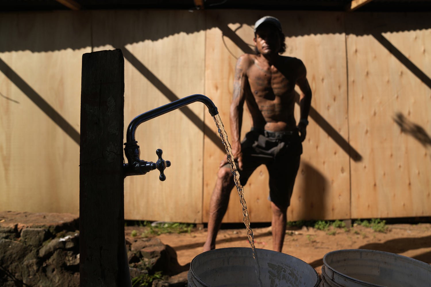  Carmelo Del Valle, who was displaced from his home by the rising waters of the Paraguay River, fills buckets with water to haul to his temporary shelter in Asuncion, Paraguay, March 18, 2023. (AP Photo/Jorge Saenz) 