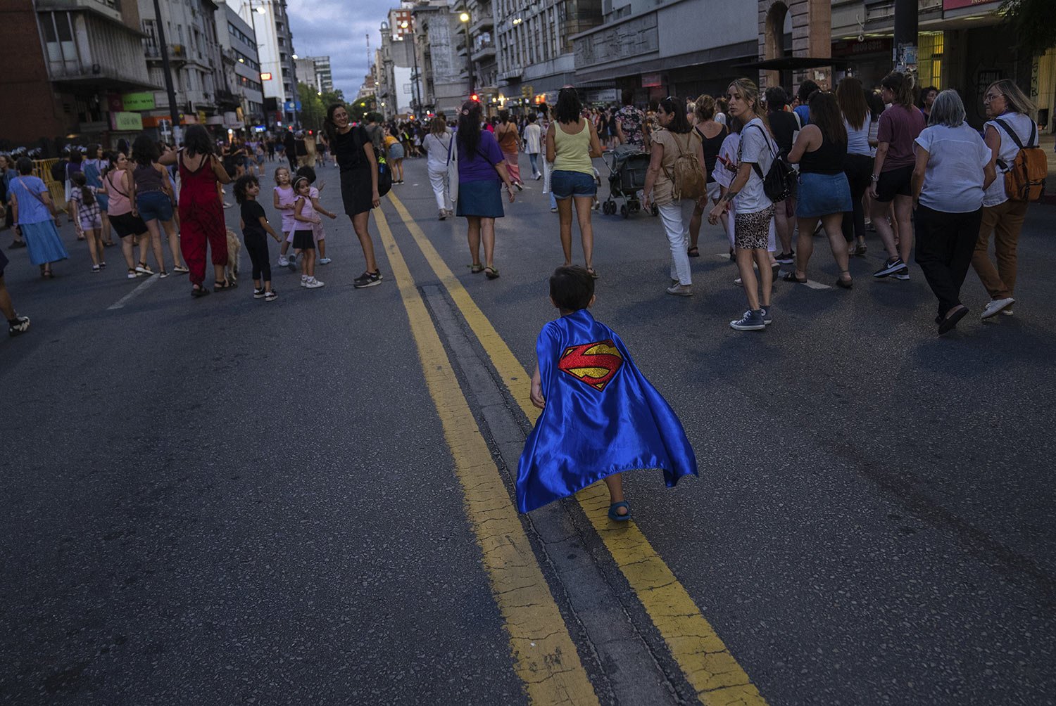  A boy in a Superman cape runs during a rally to mark International Women's Day in Montevideo, Uruguay, Wednesday, March 8, 2023. (AP Photo/Matilde Campodonico) 