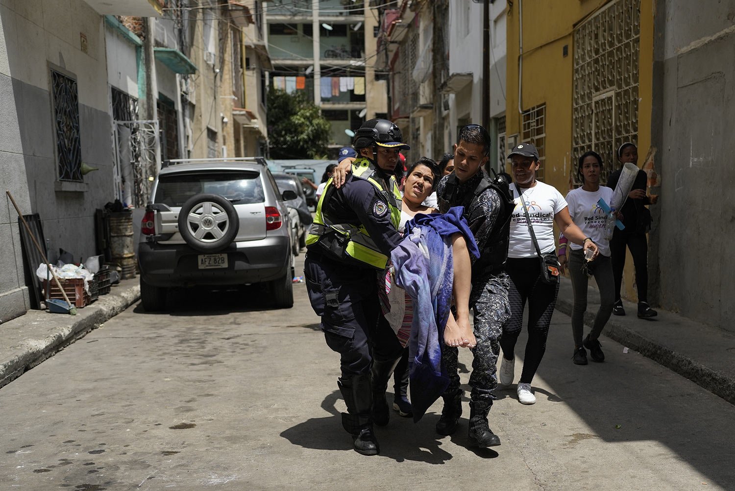  Police carry a woman to a hospital after she gave birth to a baby boy inside her apartment in Caracas, Venezuela, March 8, 2023. Nurses who were protesting nearby for a better salaries on International Woman's Day helped deliver the baby and cut the
