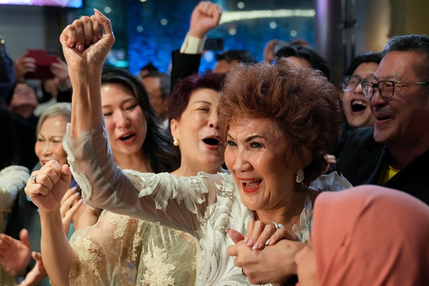  Janet Yeoh, mother of Michelle Yeoh, celebrates after her daughter won in the best actress category during the 95th Academy Awards in Los Angeles, as seen in a live view event at a cinema in Kuala Lumpur, Malaysia, Monday, March 13, 2023. (AP Photo/
