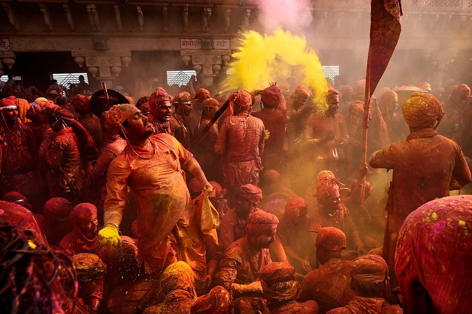  Men from Barsana village smeared with colors play Holi at Nandagram temple in Nandgoan village, 115 kilometers (70 miles) south of New Delhi, India, Wednesday, March 1, 2023.  (AP Photo/Deepanshu Aggarwal) 
