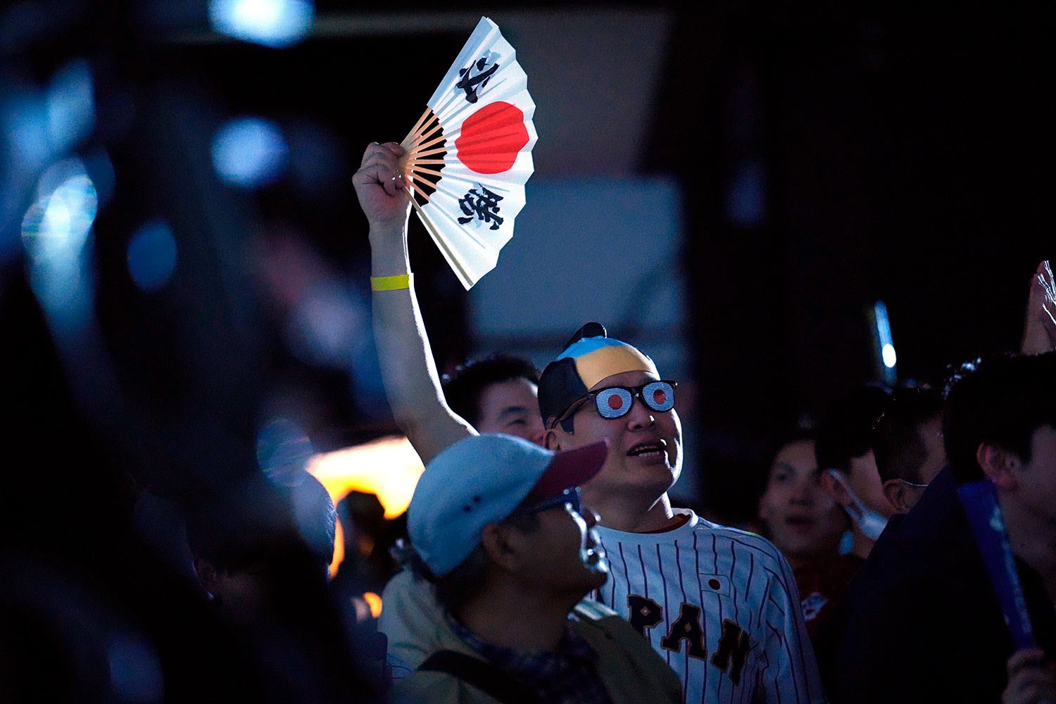  Japan fans react after Japan's Masataka Yoshida hit a home rum in the 7th inning as they watch on a live stream of a World Baseball Classic (WBC) semifinal between Japan and Mexico being played at LoanDepot Park in Miami, during a public viewing eve