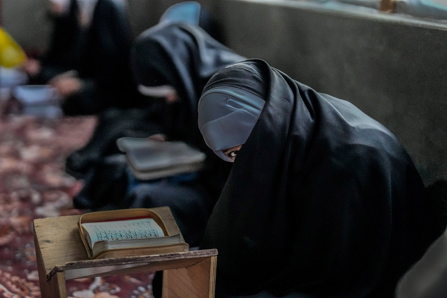  A Kashmiri Muslim girl reacts to camera as she attends recitation classes of the holy Quran during the fasting month of Ramadan in Srinagar, Indian-controlled Kashmir, Sunday, March 26, 2023. (AP Photo/Mukhtar Khan) 