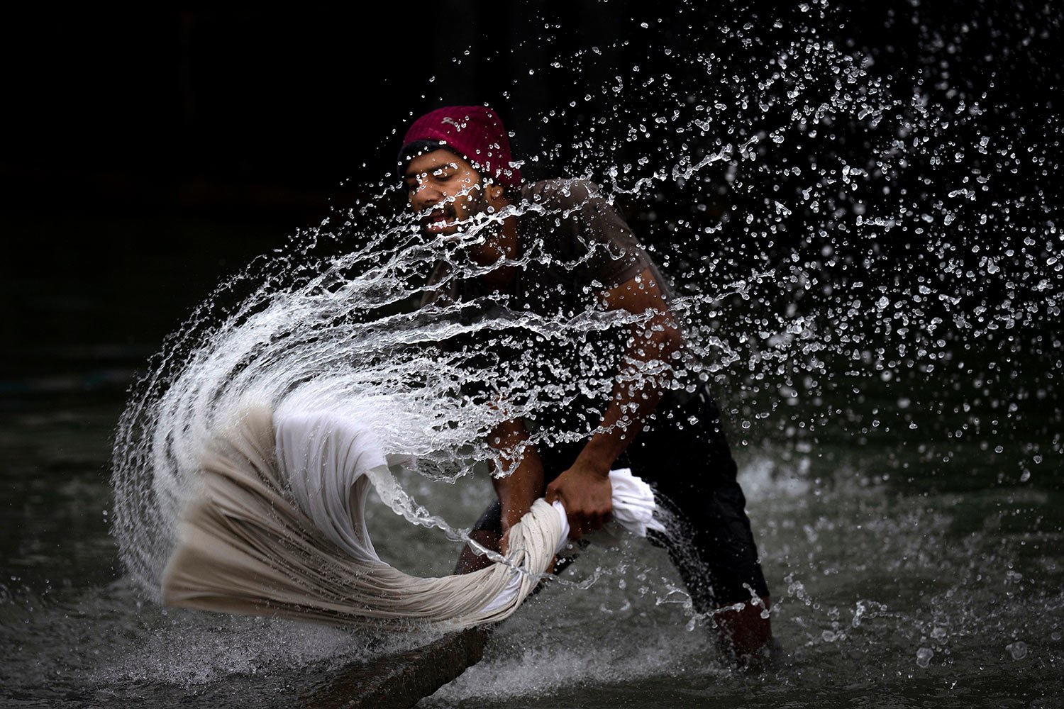  A washerman washes clothes on the banks of the river Brahmaputra on World Water Day in Guwahati, India, Wednesday, March 22, 2023.  (AP Photo/Anupam Nath) 