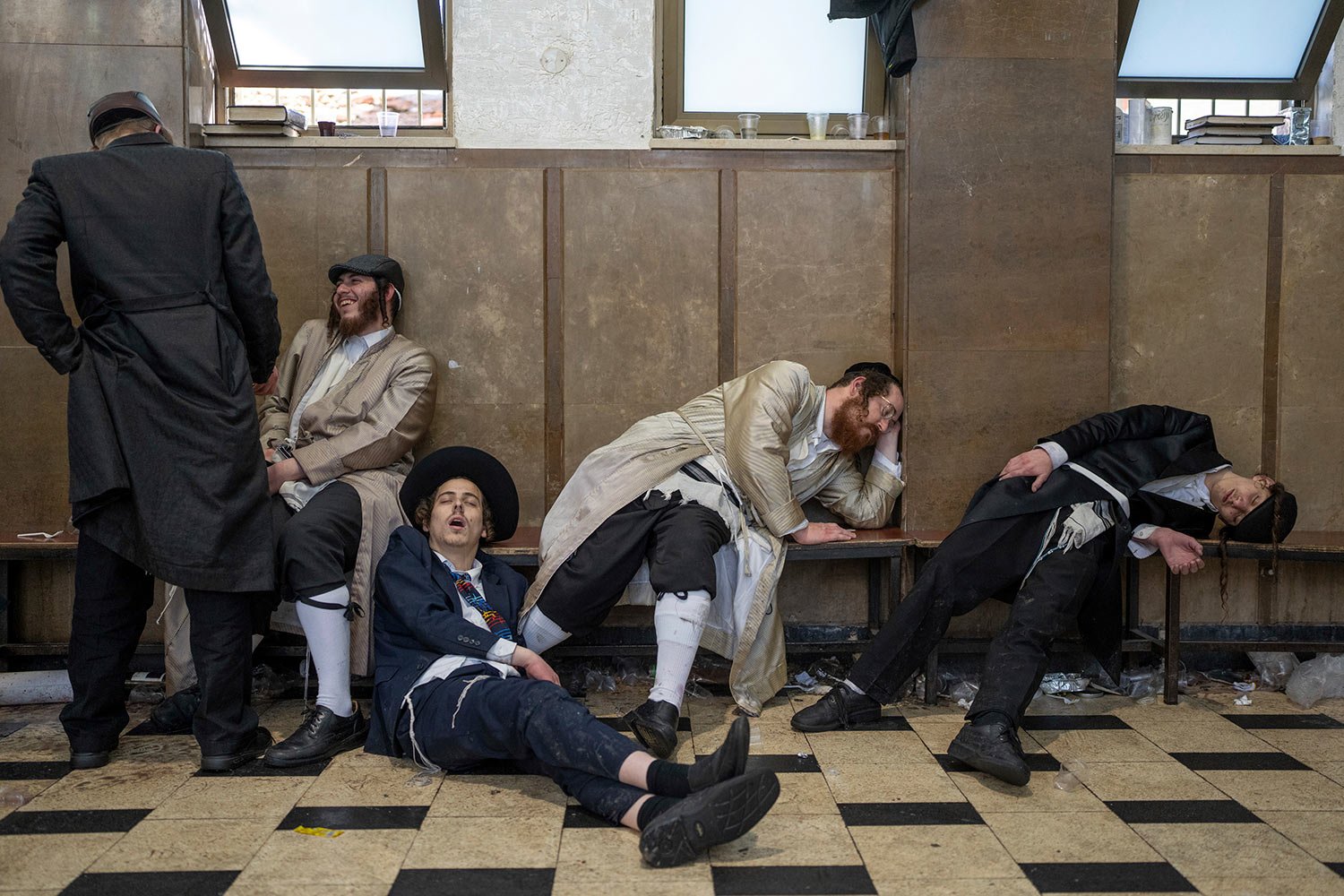  Ultra-orthodox Jewish men rest after getting drunk during celebrations of the Jewish holiday of Purim in Mea Shearim ultra-Orthodox neighborhood in Jerusalem, Wednesday, March 8, 2023. (AP Photo/Ohad Zwigenberg) 