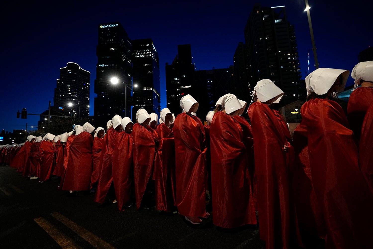  Israeli women's rights activists dressed as characters in the popular television series, "The Handmaid's Tale," protest plans by Prime Minister Benjamin Netanyahu's government to overhaul the judicial system, in Tel Aviv, Israel, Saturday, March 11,