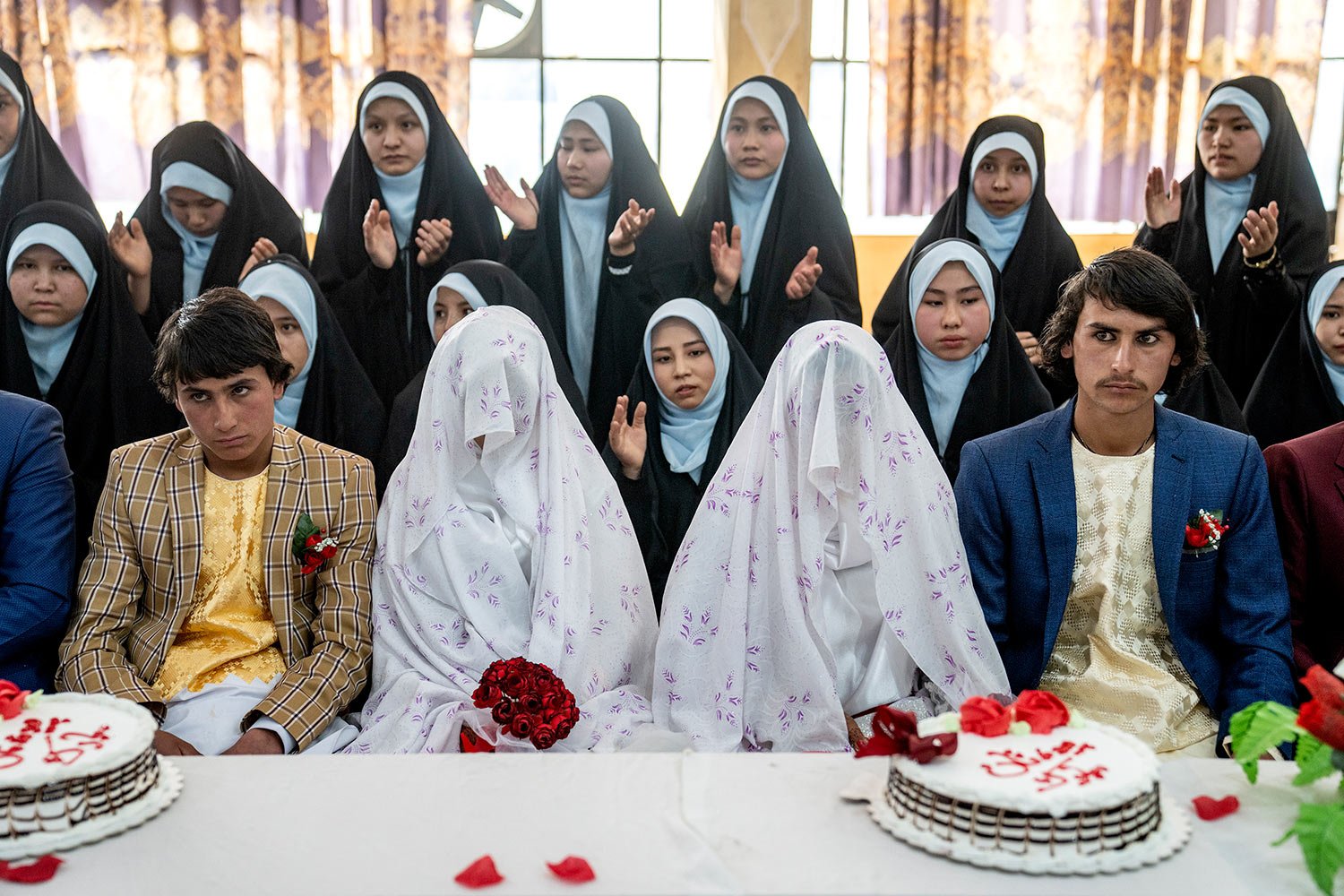  Afghan brides and grooms participate in a mass wedding ceremony during the International Women's Day, in Kabul, Afghanistan, Wednesday, March 8, 2023. (AP Photo/Ebrahim Noroozi) 