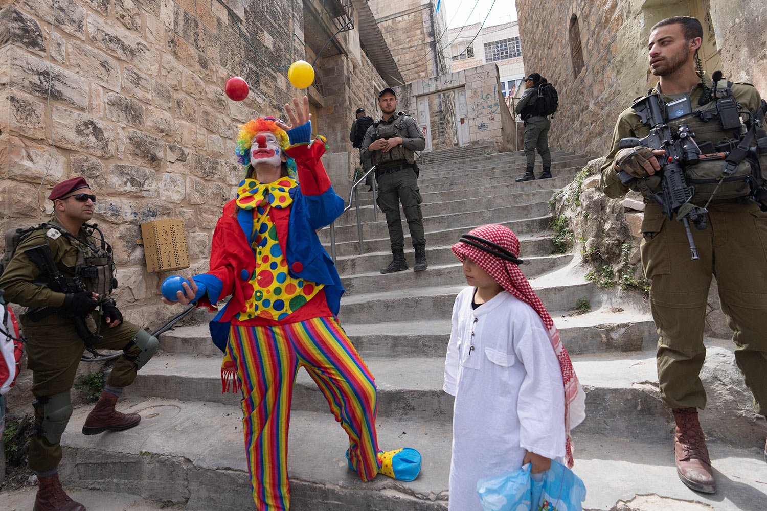  Jewish settlers dressed in costumes celebrate the Jewish holiday of Purim as soldiers secure the march in the West Bank city of Hebron, Tuesday, March 7, 2023.  (AP Photo/Ohad Zwigenberg) 