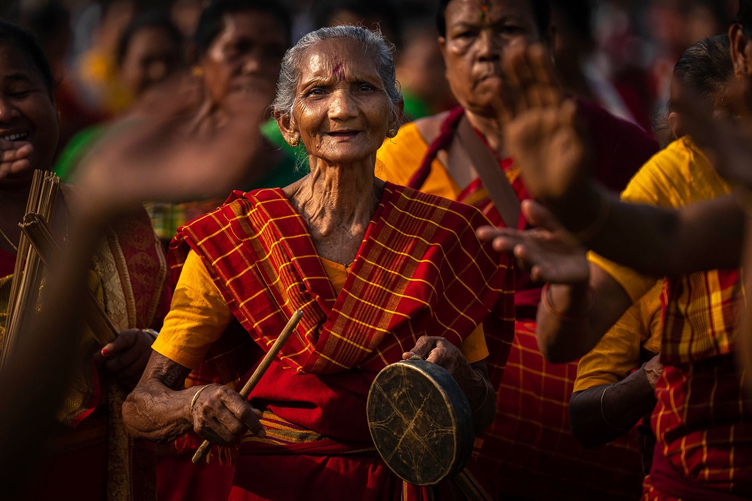  An elderly Rabha tribal woman plays a traditional instrument as they dance during Suwori festival in Boko, west of Guwahati, India, Thursday, April 20, 2023.  (AP Photo/Anupam Nath) 
